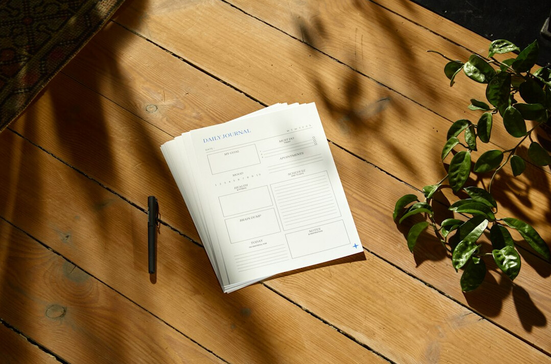 Open notebook with handwritten negotiation notes and a pen